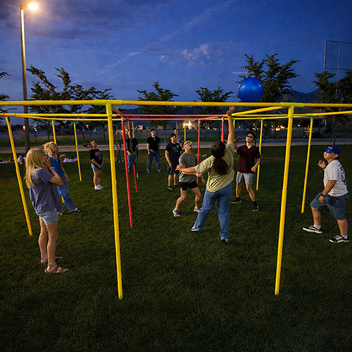 Youth playing games outdoors at dusk