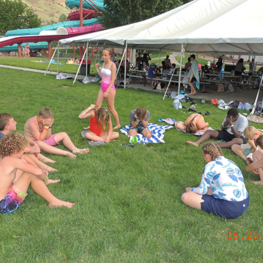 Youth relaxing on the lawn at Splash Summit waterpark